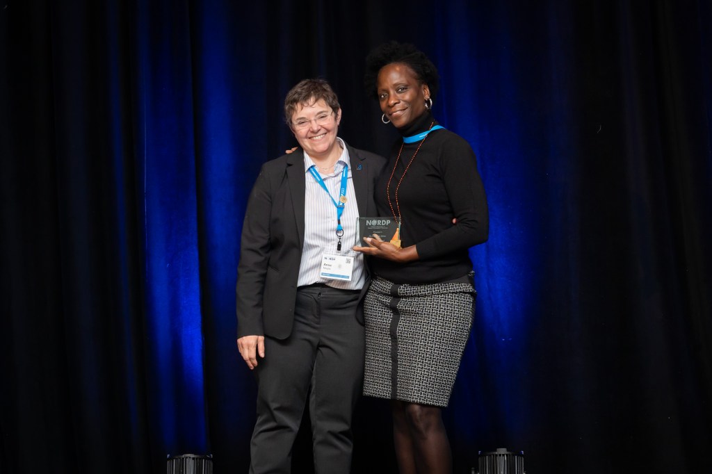 Photograph of president Anne Maglia presenting the 2023 Mentoring Award to recipient Carolynn Julien. 